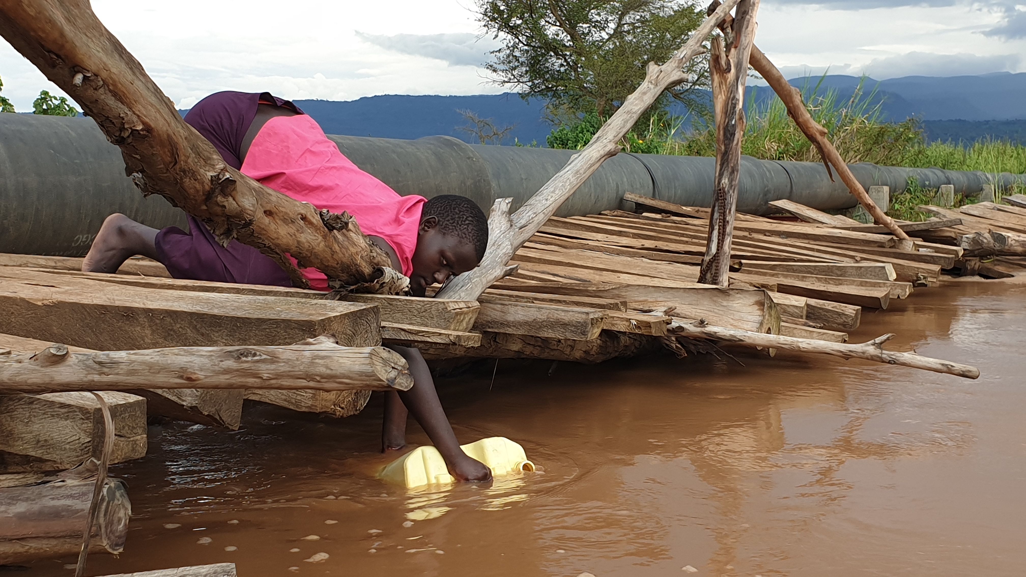 Julia Asekenya of Tajar Kolir in Bukedea district collecting water from the nearby stream which is their main source