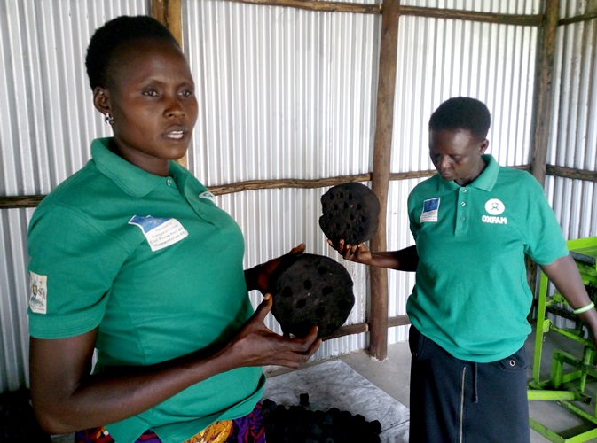 Mary Ajonye the chairperson of Loketa women group explains how the Charcoal Briquettes are made in different sizes ranging from the smollest to the biggest Photo By Robert Ariaka