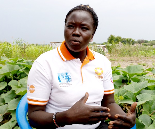 Tabu Regina the secretary Loketa women group in Ariwa village in Rhino Camp explains how they make briquettes using crop residues and human waste Photo By Robert Ariaka