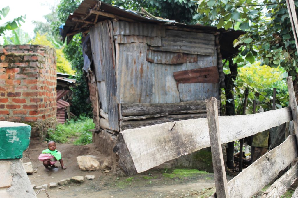 A child deficates near a toilet in Karago town council. Open defication is common. Photo by Felix Basiime