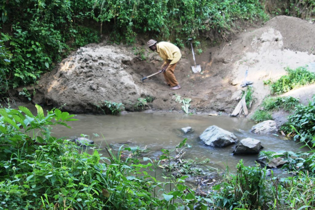 A man in Karangura sub county Kabarole district extracts sand from river Mpanga. The activity leaves water contaminated. Photo by FELIX BASIIME