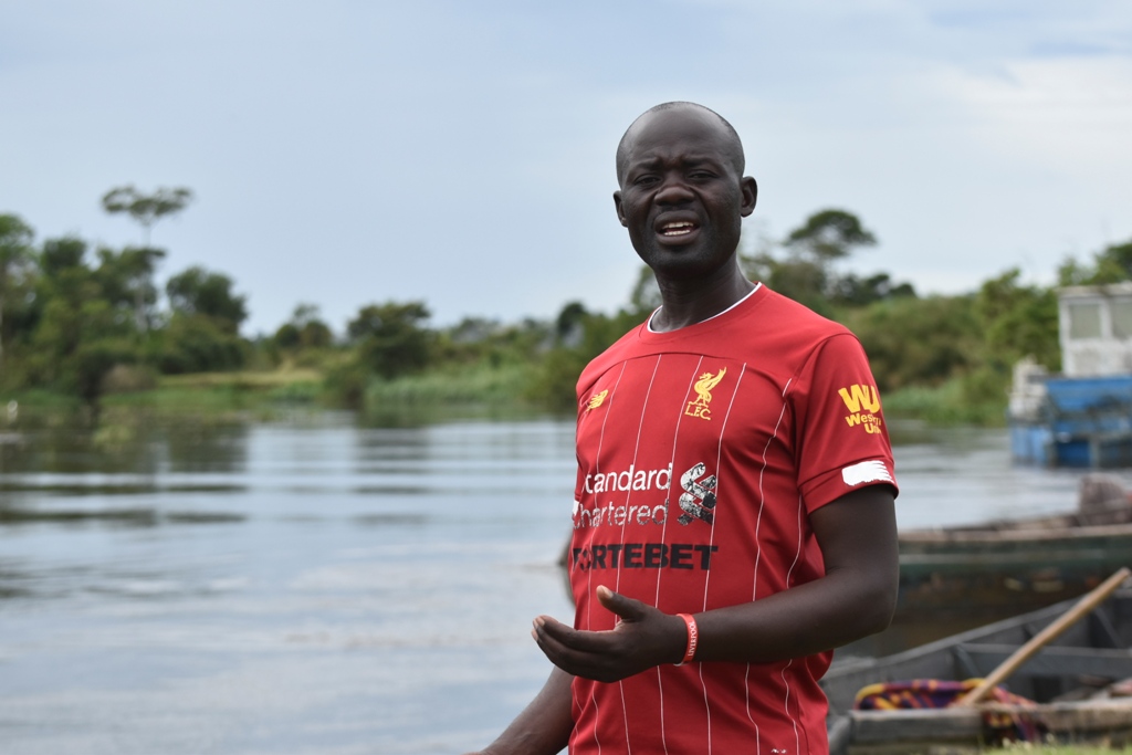 Joseph Kimera the Kasensero Town Council councilor explaining the state of the lake due to increasing pollution. Photo by Davis Buyondo
