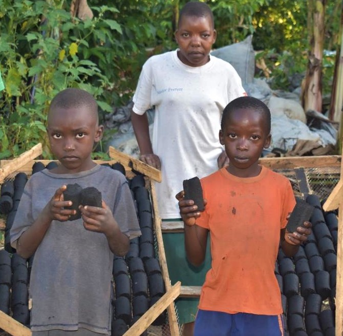 Children who learn briquettes making during their holidays. Photoby Davis Buyondo