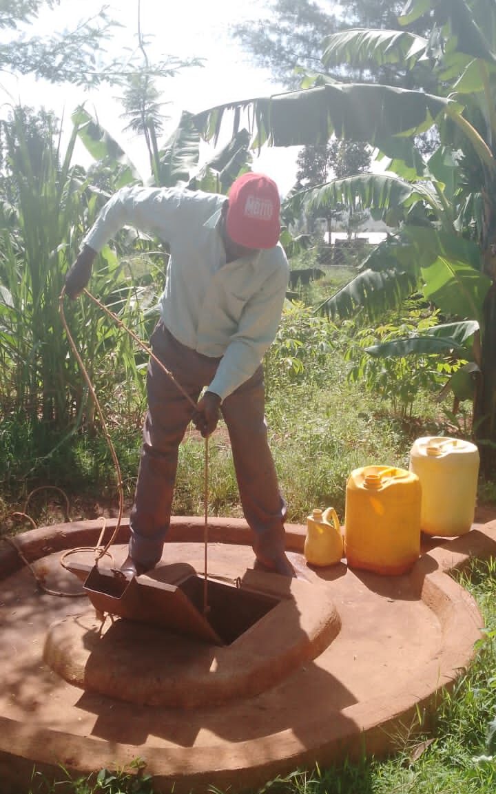 man drawing water from a well edited