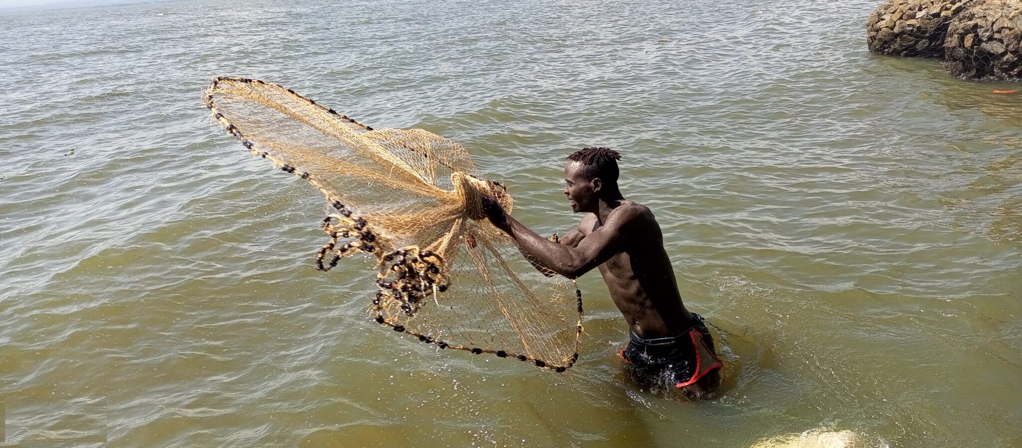 a man casting net on L. Victoria 1