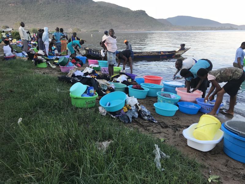 women washing at the shores of L. Victoria