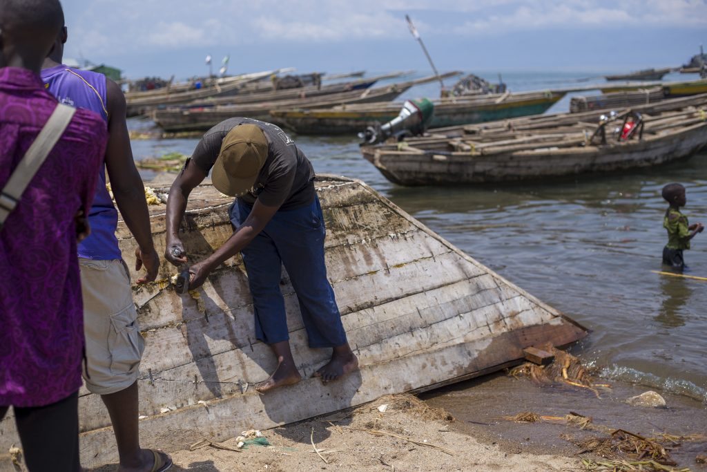 Two men mending their boats