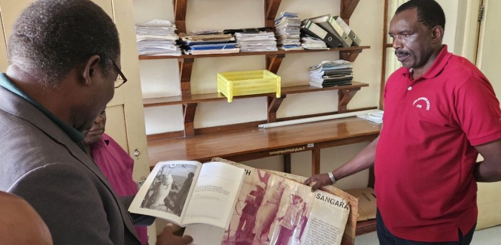 Tanzania Fisheries Research Institute TAFIRI officials display a picture of the largest fished Nile Perch in Lake Victoria at the office library in January 2