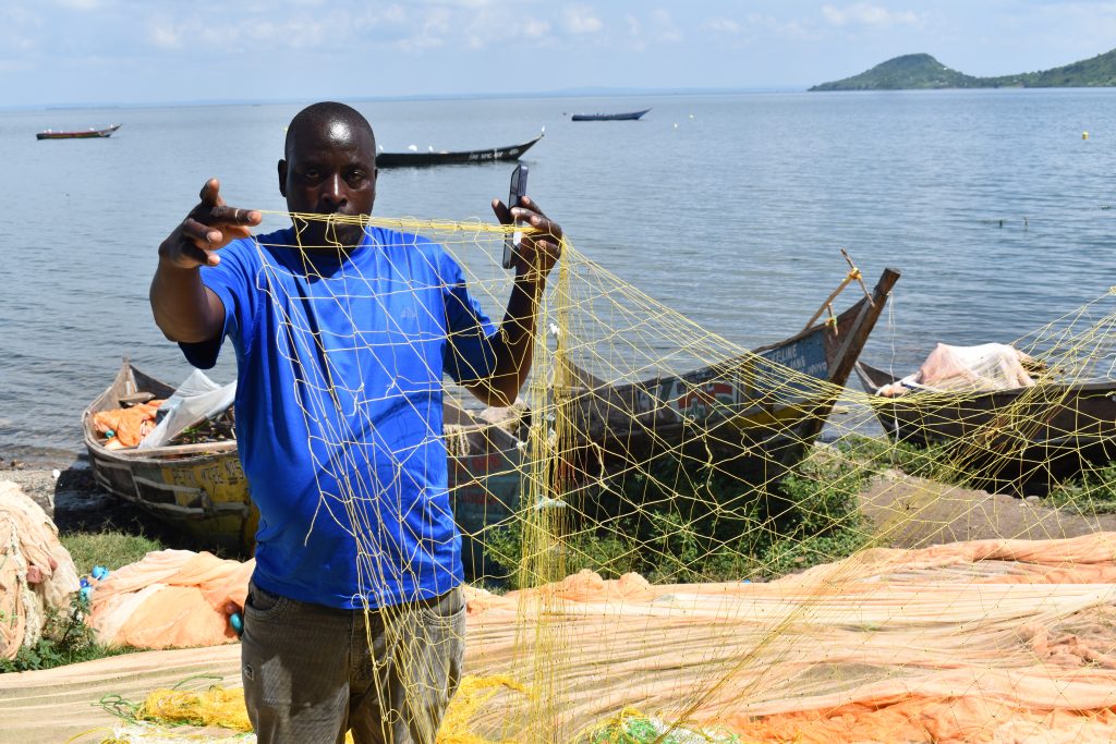 Wasungu Okeyo Assistant Chairman patrol Kiumba BMU displaying nets used for nile perch fishing