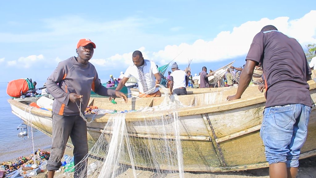 Fishermen prepare their fishing nets on the shores of Lake Edward 4