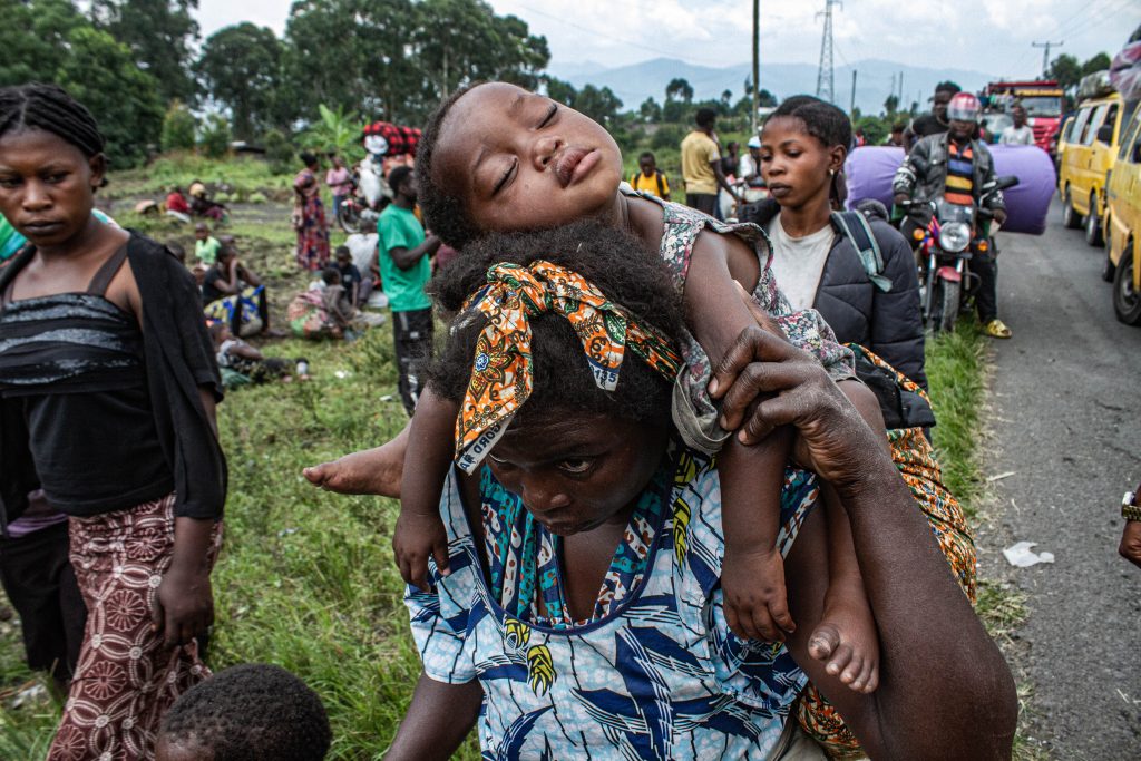 A woman carrying a baby in Rushuru Province