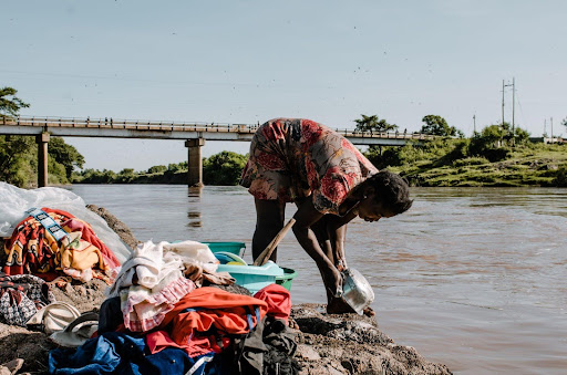 a woman washing clothes river kuja 1 2