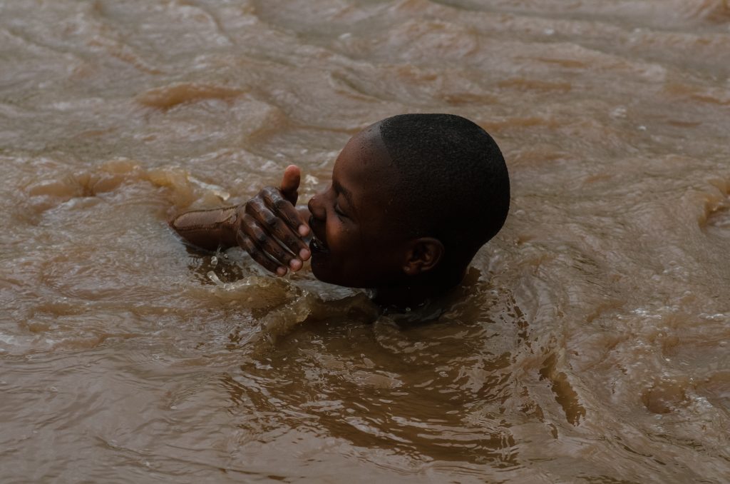a young girl swimming at River Kuja